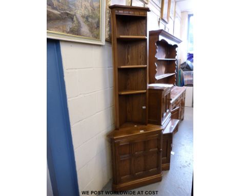 An Ercol corner cupboard with single door together with a plate rack top 