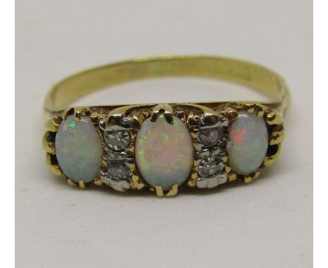 Opal and diamond ring set with three oval opals interspersed by two pairs of diamonds, marks worn, size N/O, 2.7g