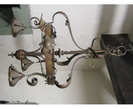 An Art Nouveau/crafts brass hanging ceiling light/electrolier with leaf and scrolled detail, supporting a band and three ligh