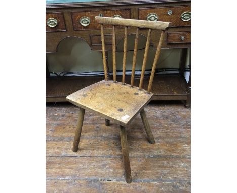 A primitive stick back chair in walnut and ash