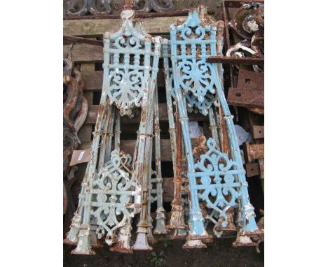 A run of thirteen reclaimed cast iron railing supports/sections with shaped outline and pierced foliate detail and layers of 