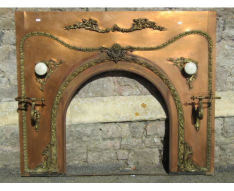 A good quality burnished copper fire insert, with arched centre and applied decorative cast gilt metal brackets, trailing fol