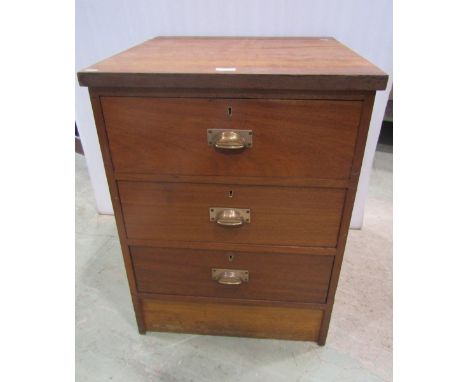 A vintage teak pedestal office chest of three long drawers with centralised cup handles, 59 cm wide x 62 cm deep x 77 cm heig