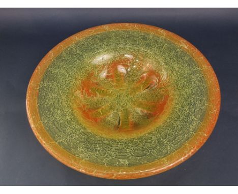 An impressive vintage mottled art glass bowl, the thick rim over a lobed bowl, in shades of orange and green, 47cm diameter