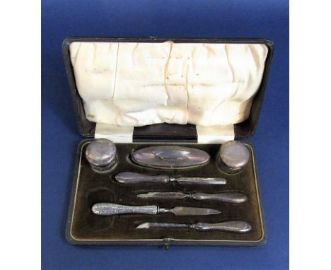 Leather cased manicure set to include two silver lidded jars, silver handled tools etc, the box 20cm long (replacements)
