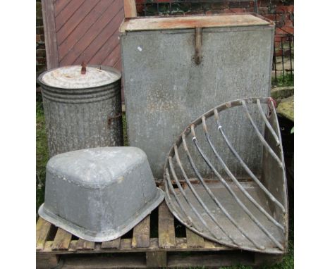 A deep galvanised storage bin corner hay manger, corner galvanised trough with rivet seams, dustbin and wheelbarrow