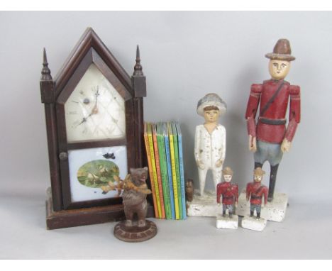 A mixed collection including an American Steeple mantel clock, an Austrian carved wood bear, four naive Canadian including th