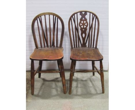 A collection of eight Windsor elm, ash and beechwood hoop and stick back chairs, five with pierced wheel splats