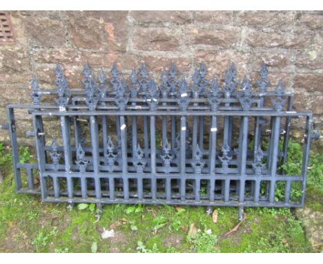 Four sections of  cast iron railing of rectangular form with vertical open rails and pointed finials, each section approx 4ft
