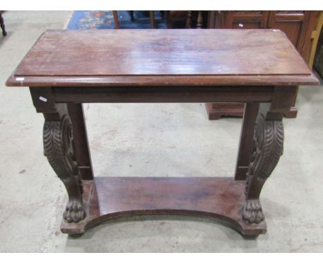 A 19th century mahogany console table of rectangular form raised on a pair of well carved scrolled forelegs with lions paw fe