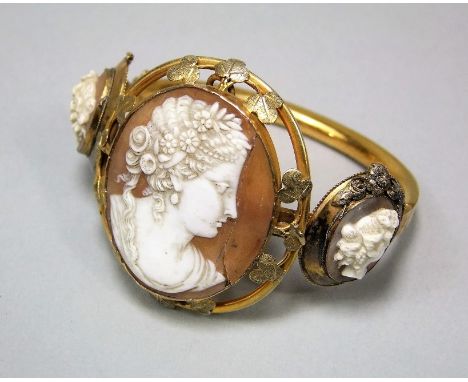 19th century triple cameo bangle, each panel depicting a classical maiden, the hinged gilt metal bracelet stamped 'T H' (af)