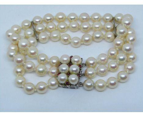Triple strand cultured pearl bracelet, the 14ct white gold clasp set with eight rubies, 18.5cm long approx
