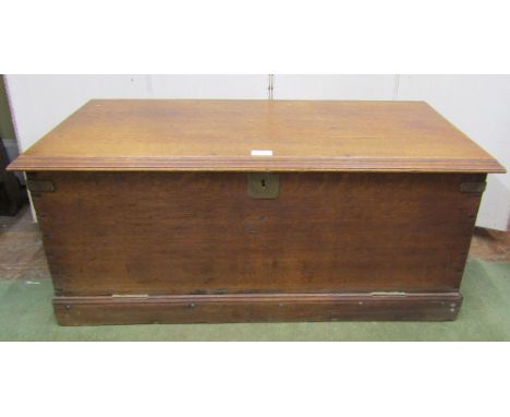 A 19th century sailors travelling trunk in oak of slight tapering form with rope handles, brass lock plate, later adapted wit