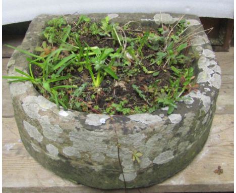 A weathered natural stone D shaped trough, approx 50cm wide x 50cm, deep x 18cm high