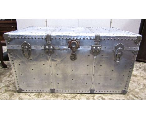 Vintage industrial polished steel and aluminium travelling trunk, with riveted detail and leather handles