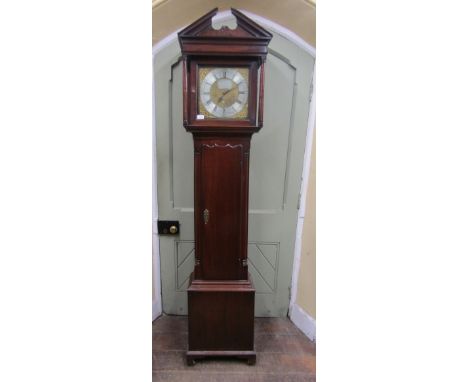 An 18th century longcase clock in walnut, the square cut hood set beneath a broken architectural pediment, enclosing a 30cm s