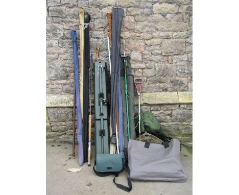 A green padded fishing holdall and rod hard case, together with a shooting stick and collection of various fishing rods