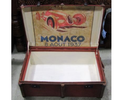 A red lacquered lathe bound trunk, the hinged lid enclosing a racing poster, to the verso side, inscribed Monaco, 8 AUT 1937,