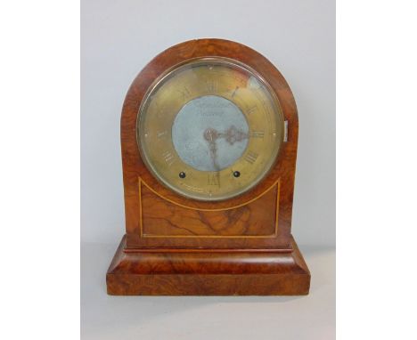 A burr walnut twin train arched case mantle clock by Johnstone of Prescot, the brass chapter ring inscribed with Roman numera