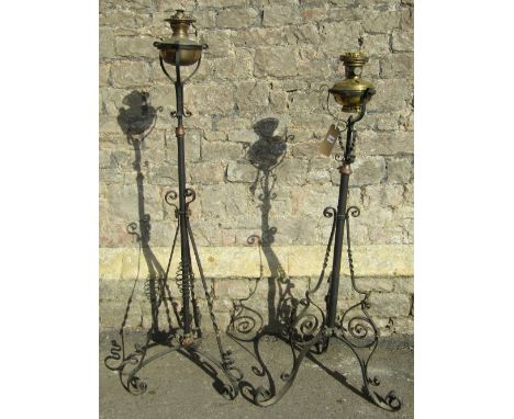 Two similar iron work telescopic floorstanding oil lamp standards with scroll work detail (later converted to electricity)