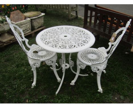 A Victorian style cream painted cast aluminium garden terrace table of circular form with decorative pierced top raised on sw