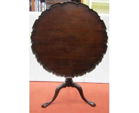 A 19th century mahogany snap top table with pie crust border, raised on a vase shaped pillar and tripod with carved detail an