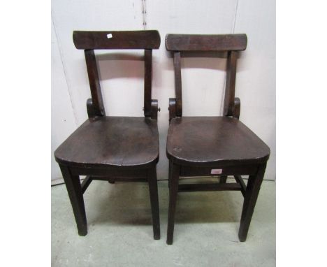 A pair of unusual vintage elm and beechwood chapel/school chairs with folding backs over solid seats raised on square tapered