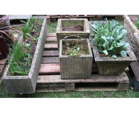 Four weathered cast composition stone garden planters of varying design, to include a flower trough of rectangular form with 
