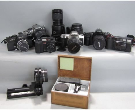 A collection of camera equipment including a Minolta SRT 101B, a Minolta Dynax 500SI and Olympus Camedia C-3040 Zoom digital 