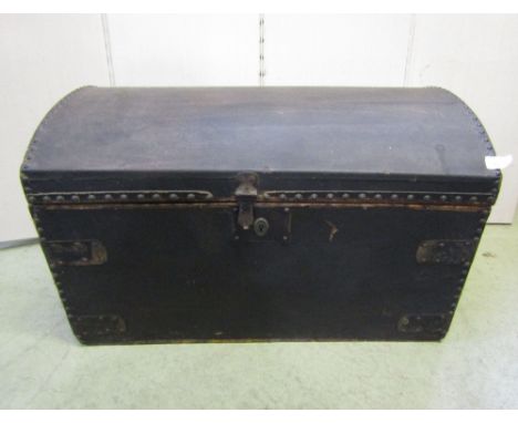 A 19th domed top trunk clad with studded detail, hinged lid and side carrying handles, labelled verso to lid E Jenkins trunk 