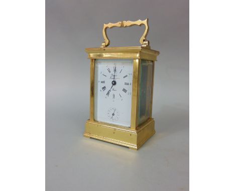 A brass cased carriage clock, the enamelled dial with Roman numerals and subsidiary second dial, 12 cm high