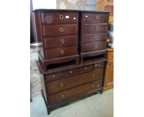 A Stag Minstral low dressing chest of four short over two long drawers, together with a pair of four drawer bedside chests wi