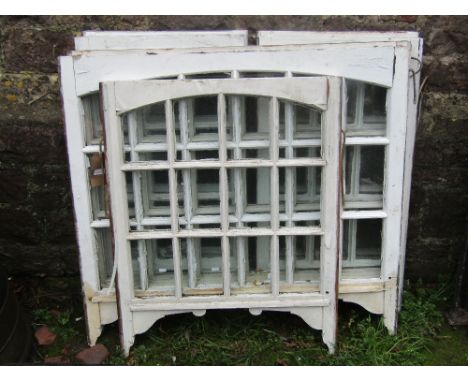 Seven reclaimed painted pine framed sash windows with segmented glazed panels