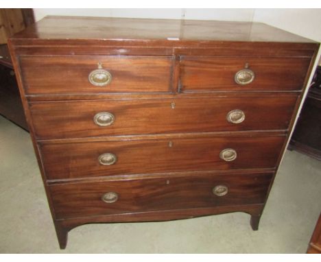 An early 19th century mahogany caddy top bedroom chest of two short over three long graduated drawers with shaped tapering br