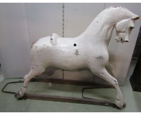 A vintage, probably Edwardian rocking horse, the wooden body with painted finish and pine stretchers (lacks base), 94 cm in h