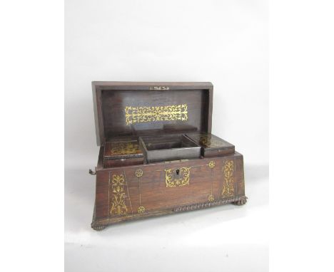 A regency rosewood sarcophagus shaped tea caddy inlaid with brass panels, the interior with two canisters and unusual square 