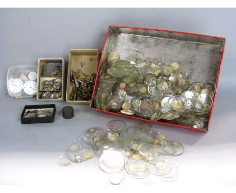 Collection of watch makers workshop items to include a box containing vintage watch glasses and various watch keys, movements