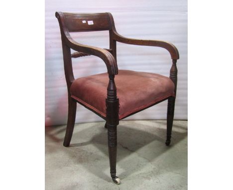 A Regency mahogany bar back open armchair with moulded frame and rope twist splat over an upholstered seat raised on ring tur