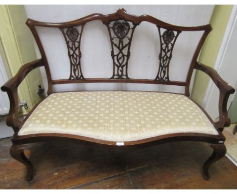 An Edwardian mahogany framed parlour room sofa, with carved and pierced splats, upholstered seats on shaped supports