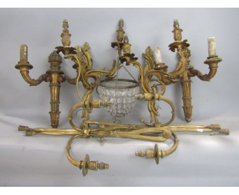Three pairs of gilded wall lights including a Rococo pair in cast brass, together with a small cut glass bag light