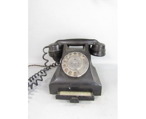 A vintage black Bakelite telephone with chrome fittings