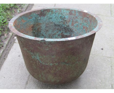 A vintage cast iron tub of circular tapered form with flared rim, 59 cm diameter