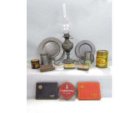 A Victorian spelter oil lamp with embossed detail, half pint pewter mug, further pewter plate, vintage tins, etc