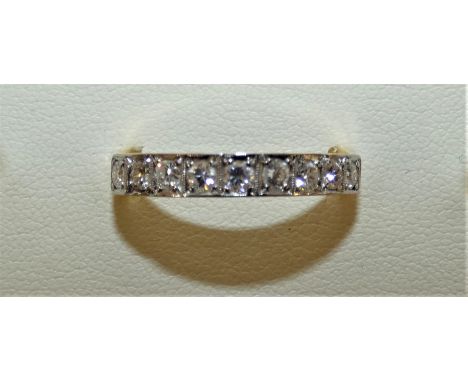 An 18ct gold 9 stone diamond ring channel set with brilliant cut stones, approx. 0.45 cts, weight 4g, size Q 1/2