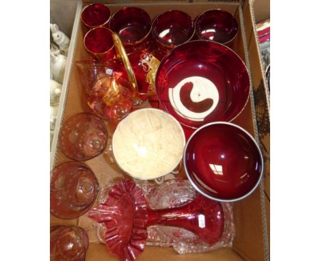 A ruby glass pedestal bowl with gilt decoration, six matching pedestal bowls, a pair of wine glasses and a basket, together w