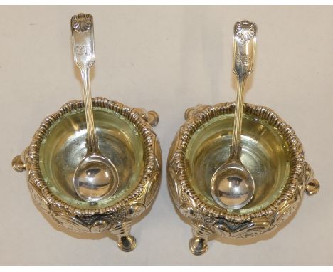 A pair of Victorian silver cauldron salts, London 1853 with embossed decoration and later fiddle, thread and shell silver spo