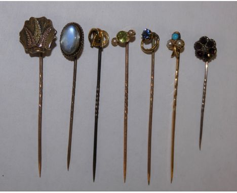 A gold turquoise and pearl stickpin, a peridot and pearl stick and 5 other sticks