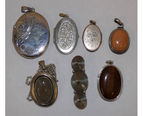 Three silver lockets, three silver pendants and a brooch