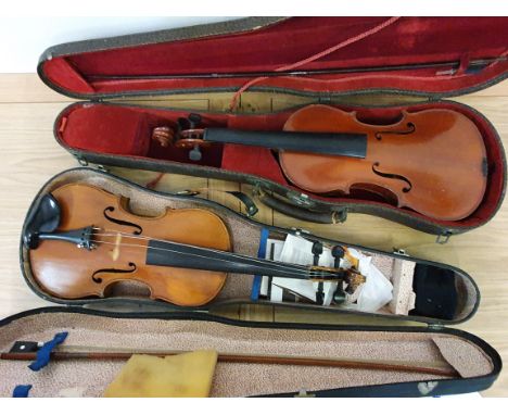 A violin with carved motif to peg box, bow, case and another violin, with Stradivarius label dated 1721, bow, case (2).