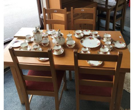 A light oak rectangular extending dining table, raised on square legs, 75 x 76 x 204 cm extended, 4 matching chairs, a cabine